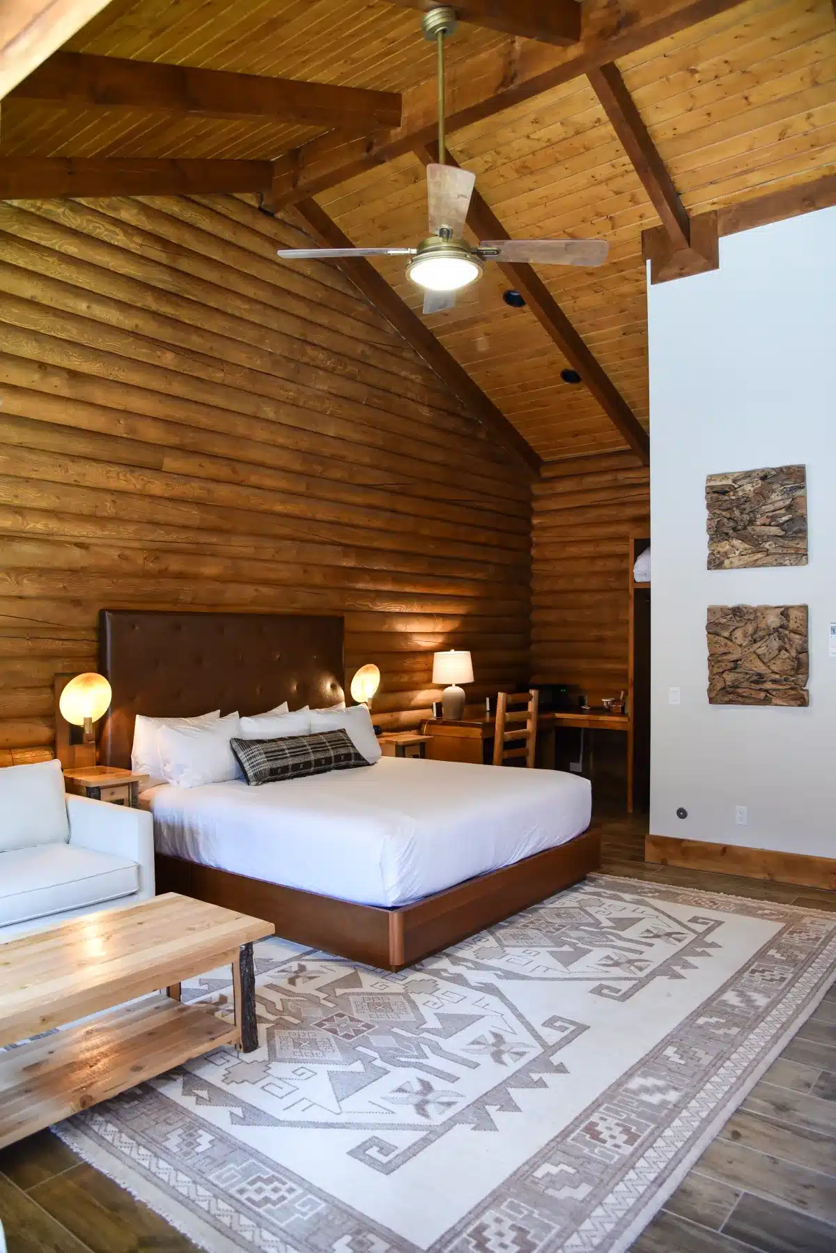 Timber at Holly Branch room with warm wood walls and king bed